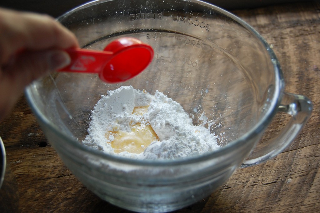 adding liquid to powdered sugar