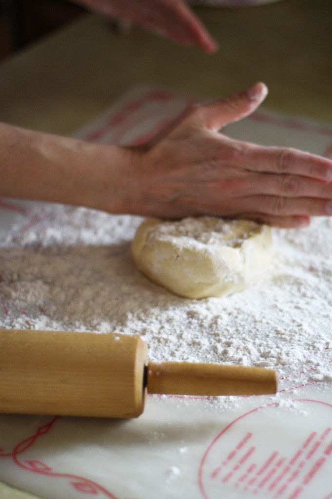 putting dough on surface to roll out