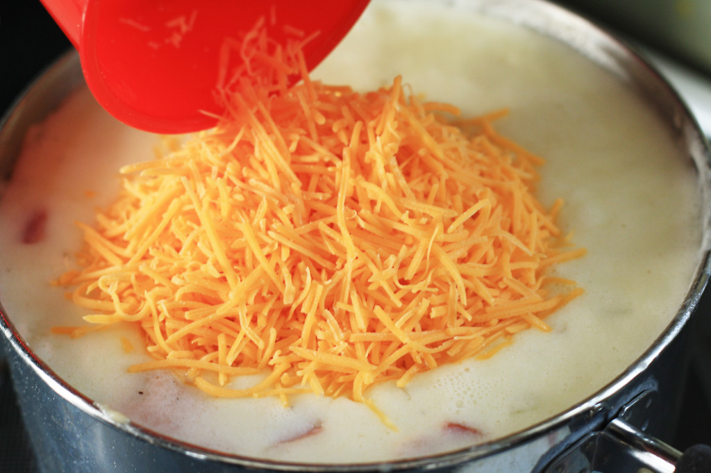 adding cheese to potato soup