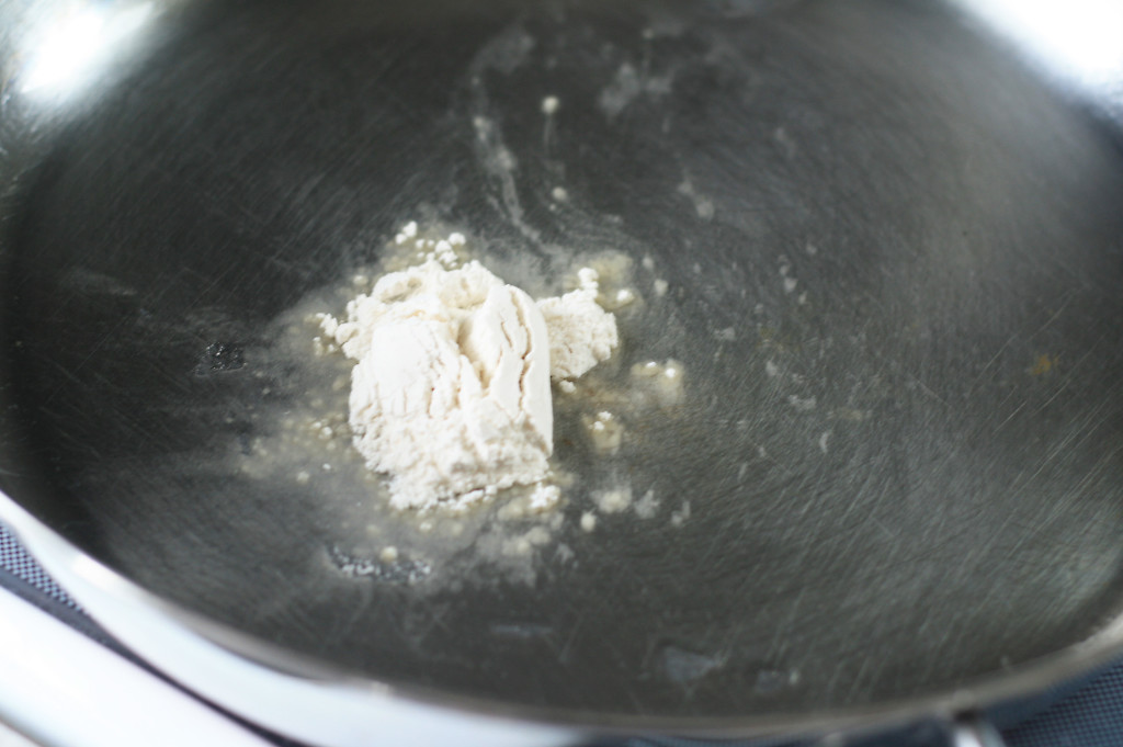 adding flour to sauce
